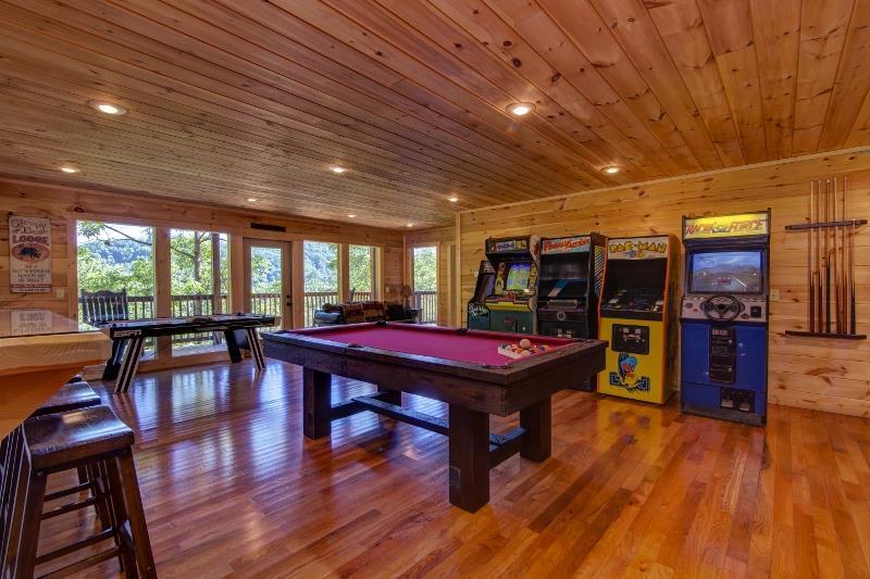 Game room with pool table and arcade games