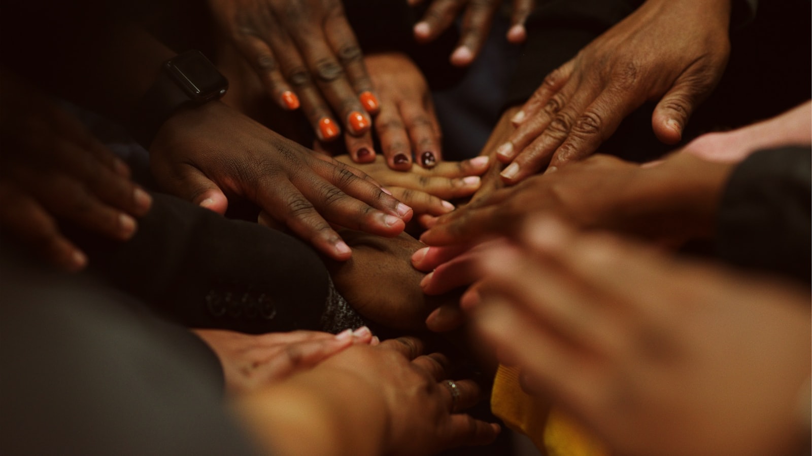 Group joining hands at a church retreat